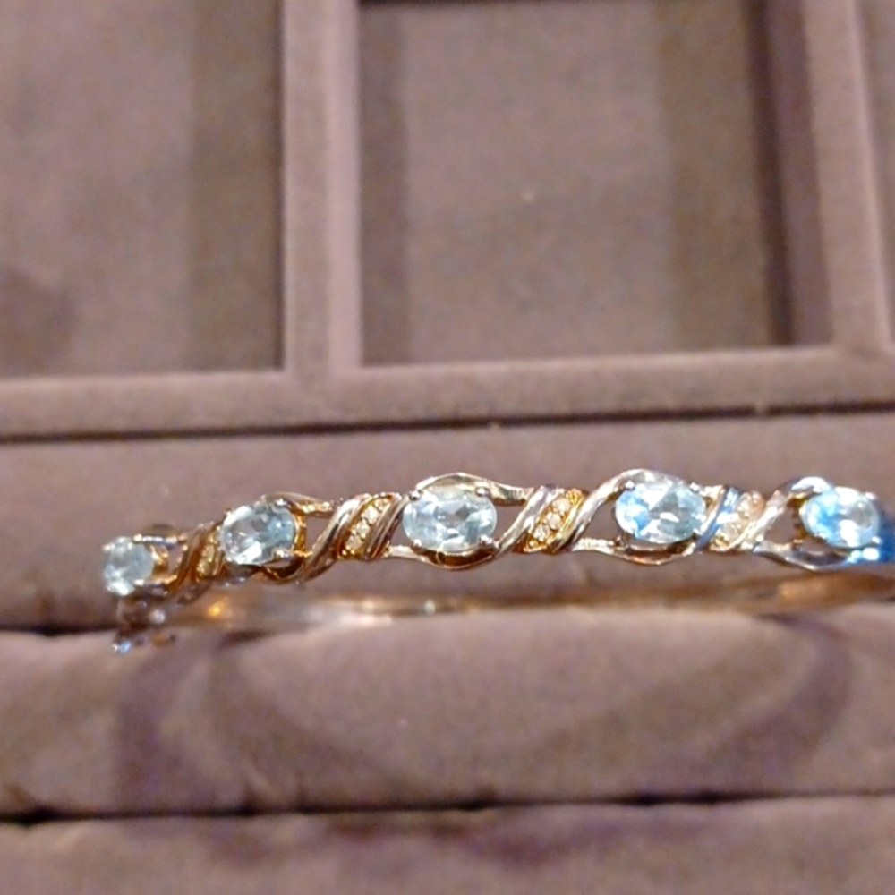 Blue topaz bangle bracelet with safety catch